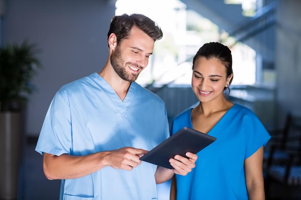 a woman and a man doctors looking at patient file